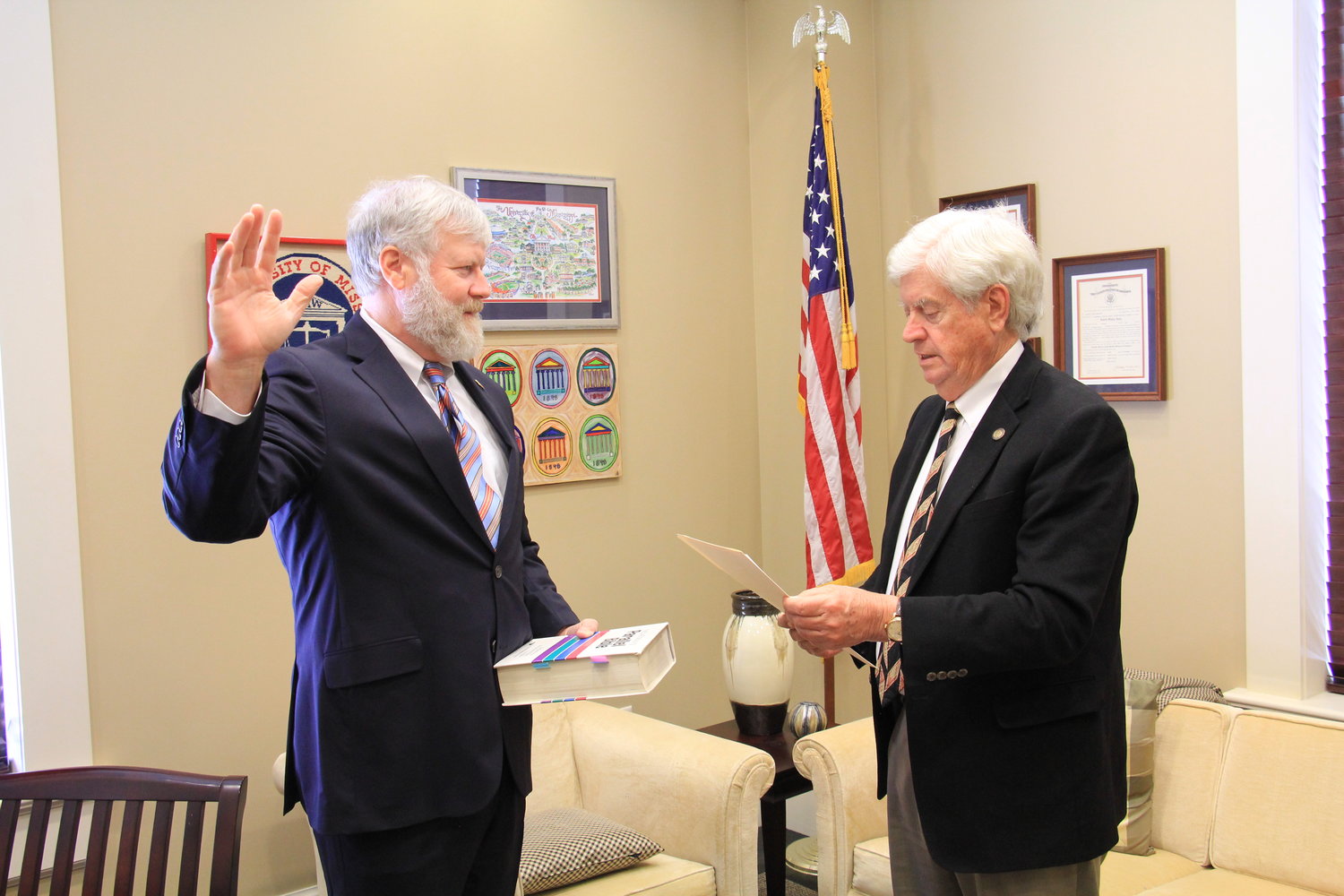 Supreme Court Justice Kenny Griffis, at left, takes the oath of office on Jan. 3. Chief Justice Mike Randolph, at right, administers the oath.